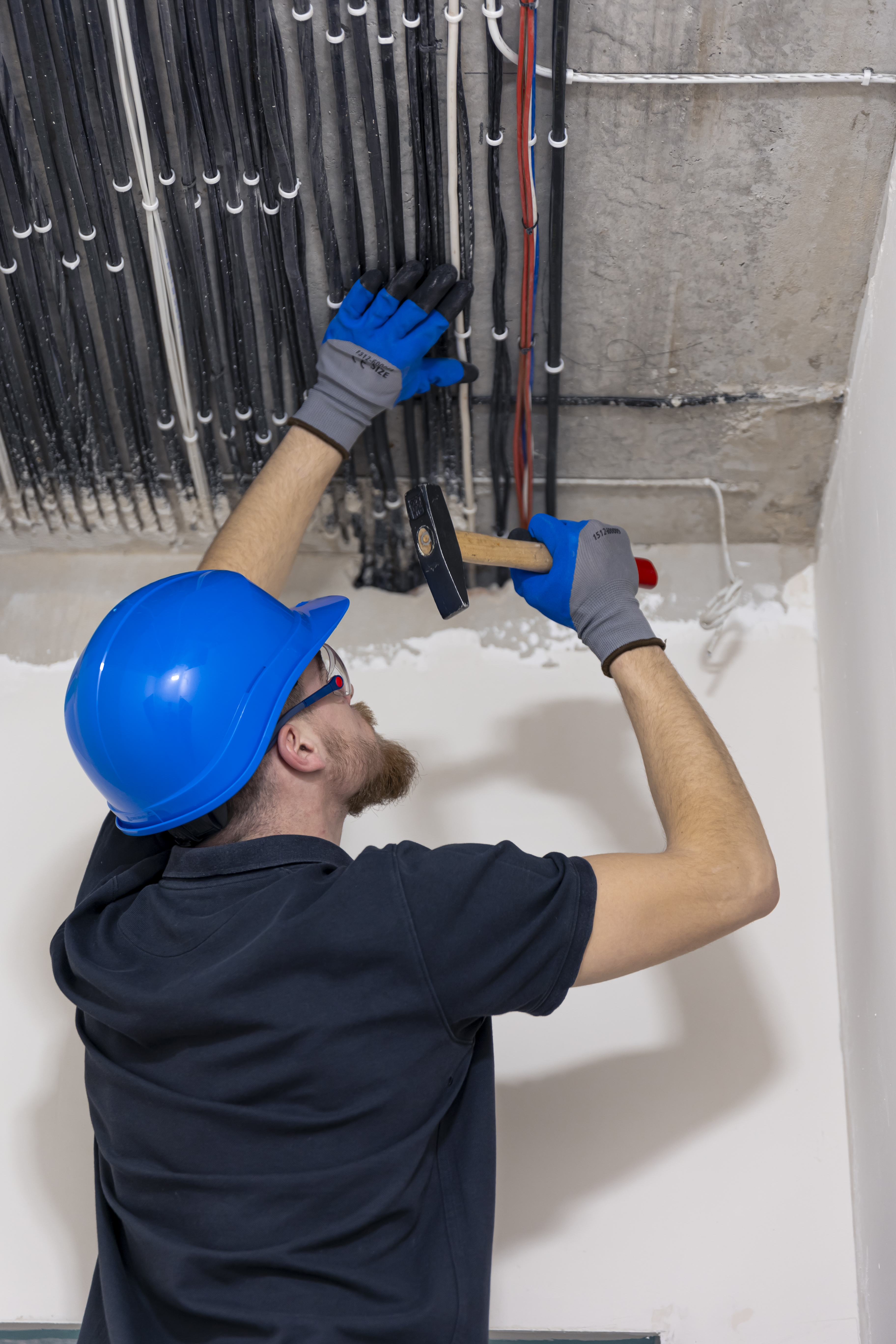 electrician-installing-laying-electrical-cables-ceiling-inside-house